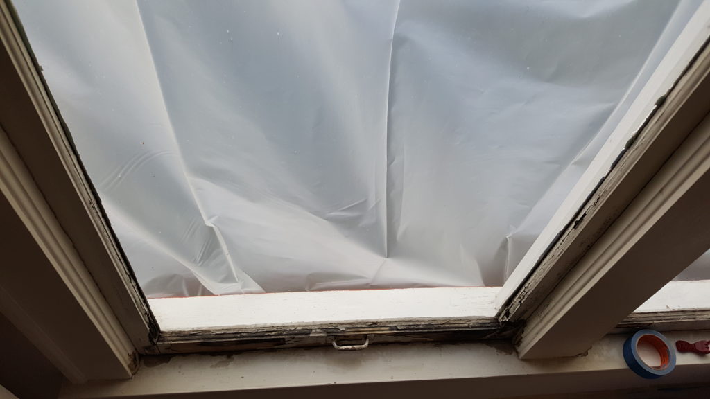 flaking paint on lower sash of a double hung window