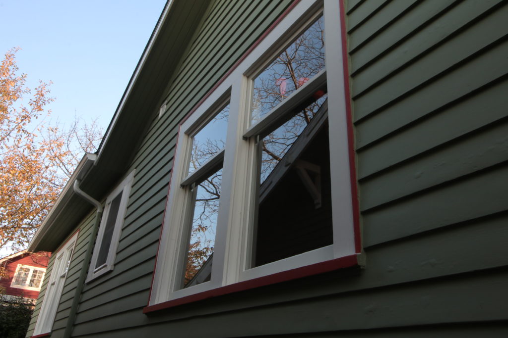 exterior photo of double hung windows. reflection off the glass